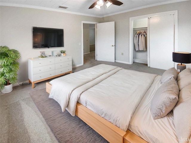 carpeted bedroom featuring ceiling fan, a closet, and ornamental molding