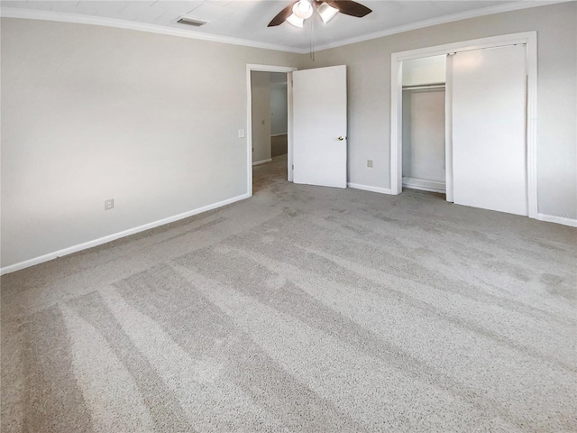 unfurnished bedroom with ceiling fan, light carpet, and crown molding