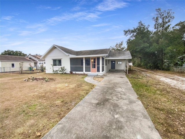 single story home featuring a front lawn and a sunroom