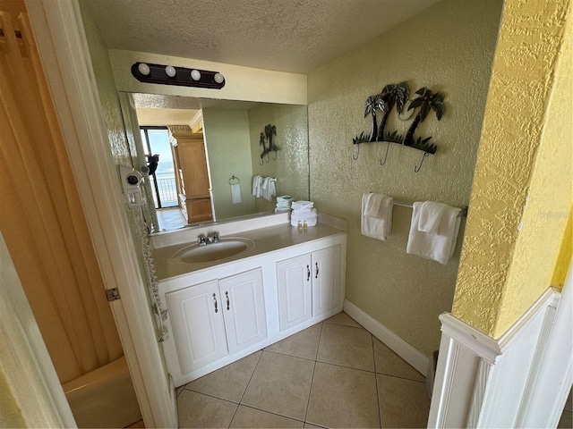 bathroom featuring a textured ceiling, tile patterned floors, and vanity