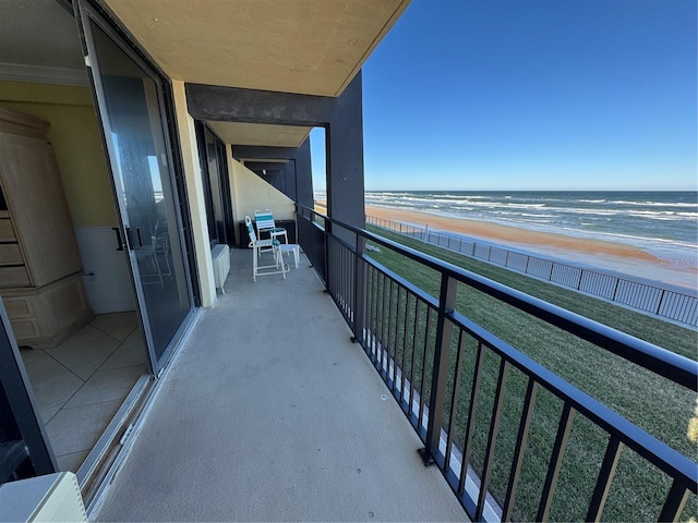 balcony with a water view and a beach view