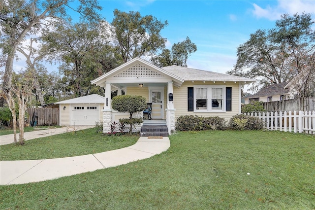 view of front of home featuring a garage, a front yard, an outdoor structure, and a porch