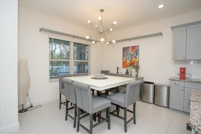 dining space featuring a notable chandelier and light tile patterned floors