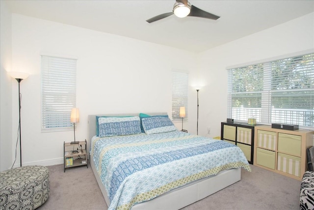 bedroom featuring light carpet and ceiling fan