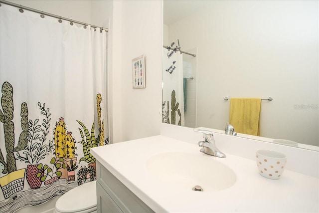 bathroom featuring vanity and toilet