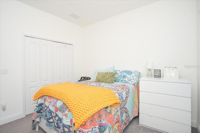 bedroom featuring light carpet and a closet