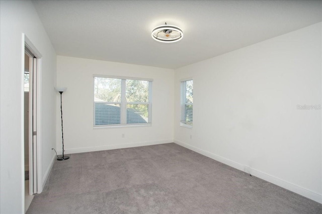 unfurnished room featuring light colored carpet