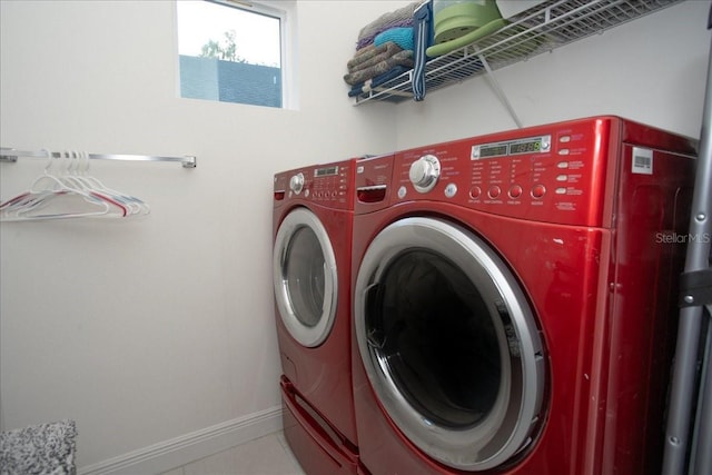 laundry area featuring washing machine and dryer and tile patterned floors