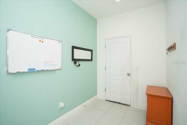 hall with light tile patterned floors