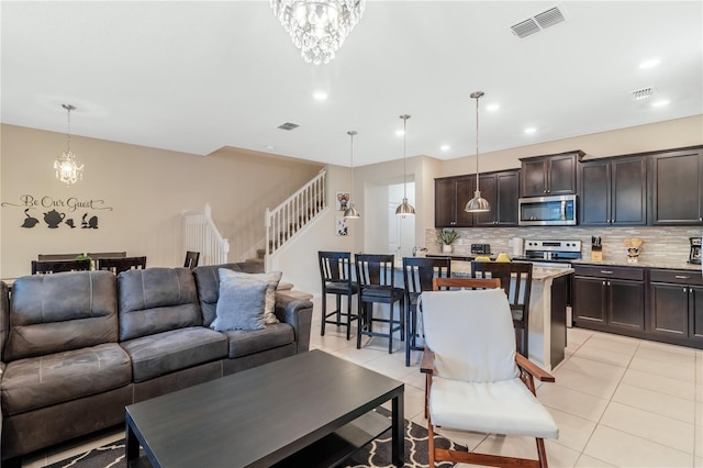 living room with an inviting chandelier and light tile patterned flooring