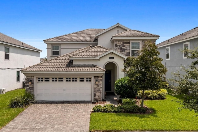 mediterranean / spanish-style house featuring a front lawn