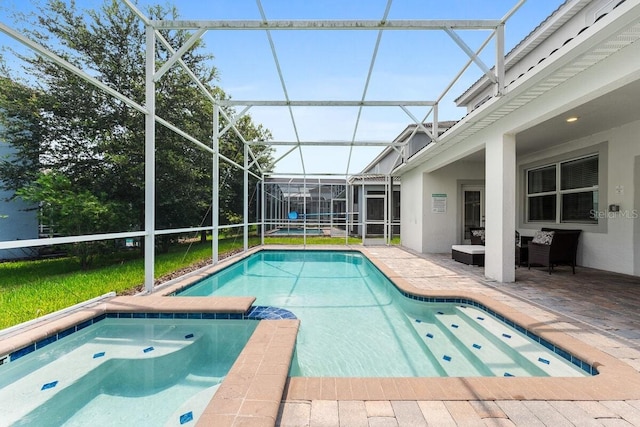 view of pool featuring glass enclosure and a patio area