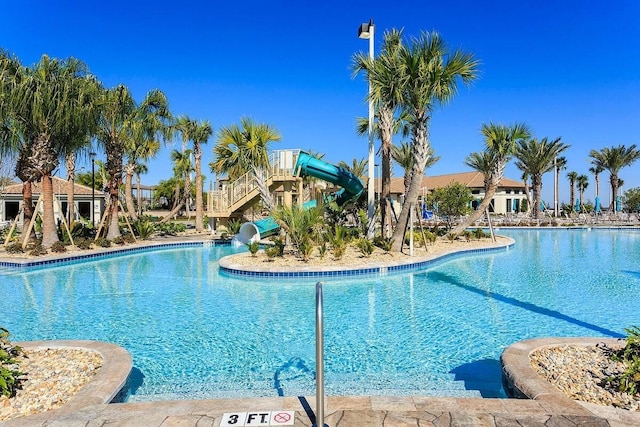 view of swimming pool with a water slide