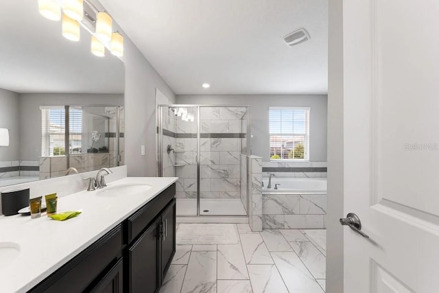 bathroom featuring separate shower and tub, a wealth of natural light, and vanity