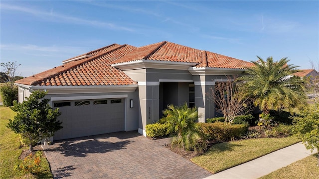 mediterranean / spanish-style home with a garage