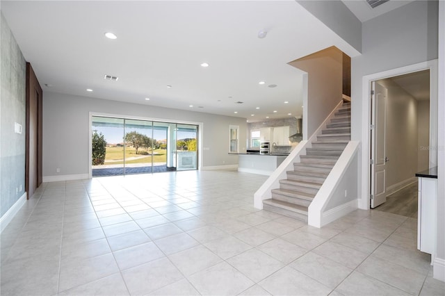 unfurnished living room with light tile patterned flooring