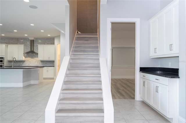 stairway with tile patterned flooring and sink