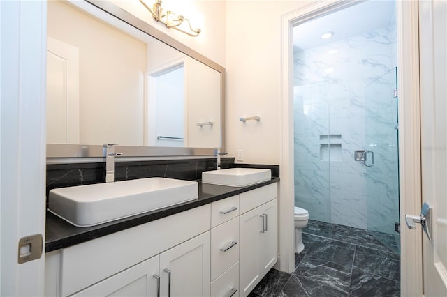 bathroom featuring vanity, toilet, and an enclosed shower