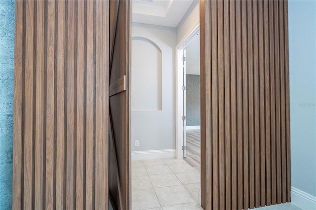 corridor featuring light tile patterned floors