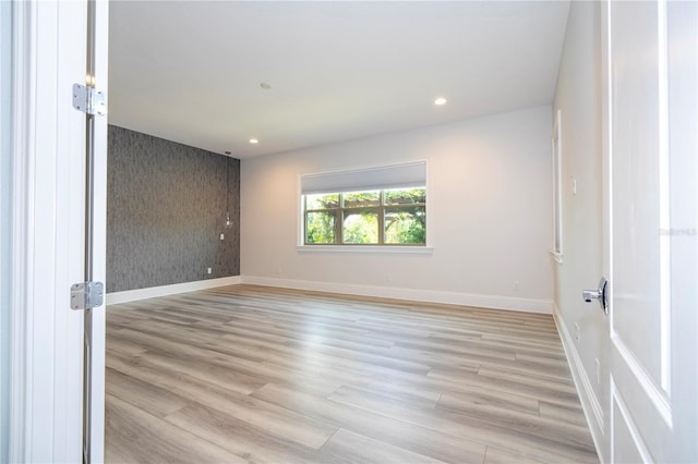 unfurnished room with light hardwood / wood-style floors