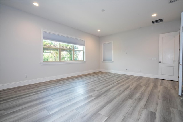 unfurnished room with light hardwood / wood-style floors