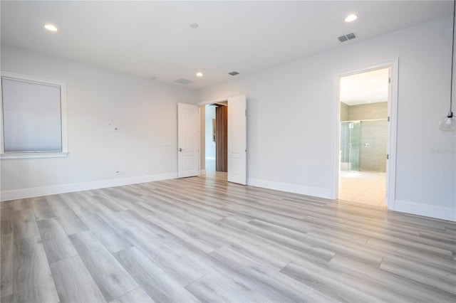 spare room with light hardwood / wood-style flooring