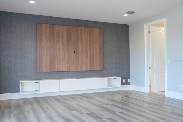 unfurnished room with light wood-type flooring