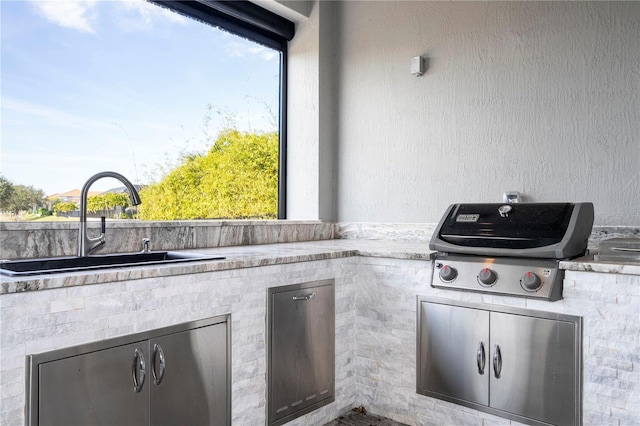 view of patio with grilling area, exterior kitchen, and sink