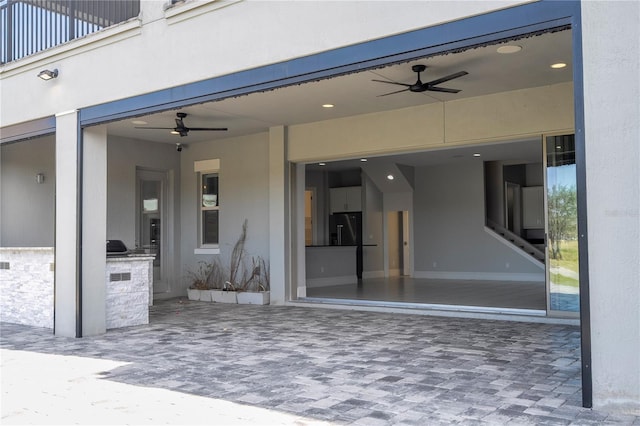 view of patio / terrace with a balcony and exterior kitchen