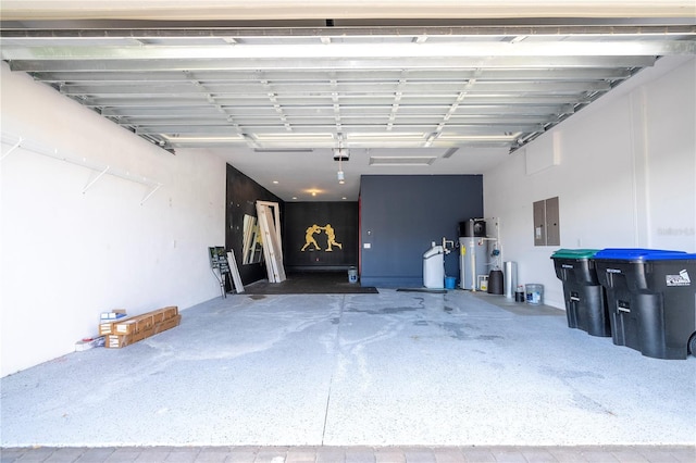 garage with a garage door opener and electric panel