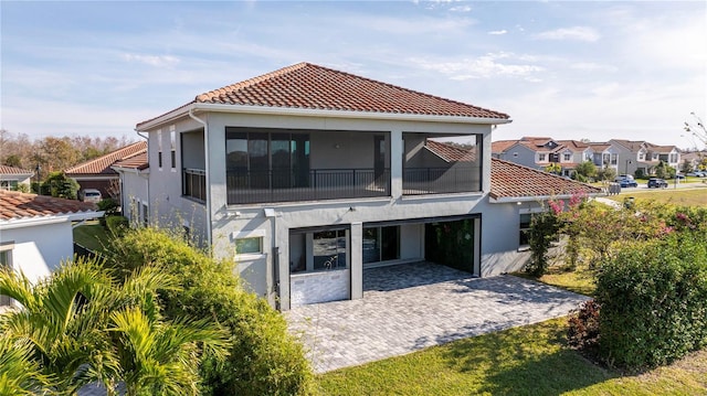 back of property featuring a patio area and a balcony