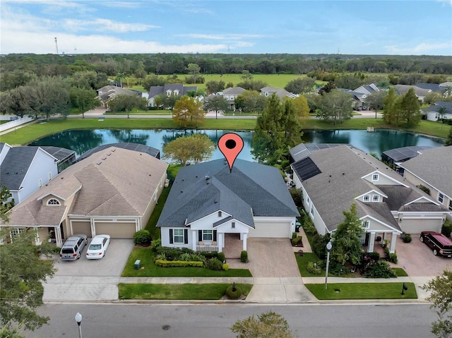 birds eye view of property with a water view