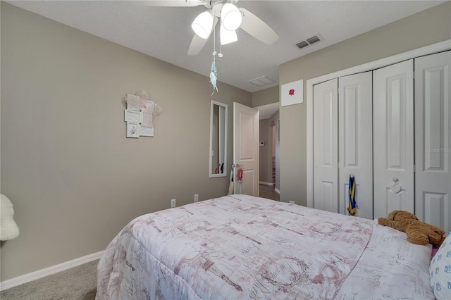 carpeted bedroom featuring ceiling fan and a closet