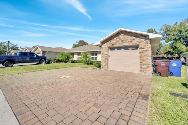 view of front of property with a garage and a front yard