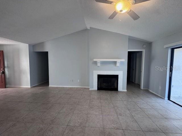 unfurnished living room with ceiling fan, light tile patterned flooring, a textured ceiling, and lofted ceiling