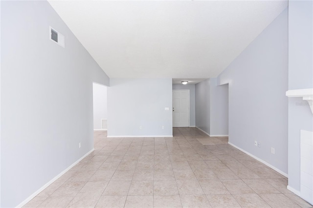 unfurnished room with light tile patterned floors, visible vents, and baseboards