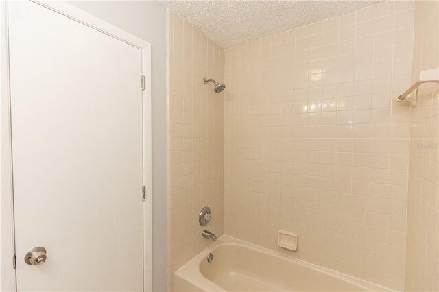 full bathroom featuring shower / washtub combination and a textured ceiling