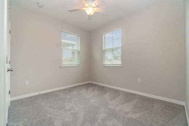 unfurnished room featuring ceiling fan and carpet flooring