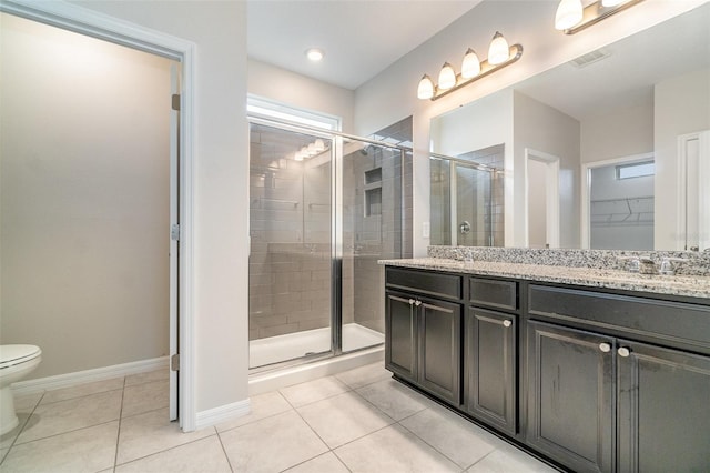 bathroom with an enclosed shower, vanity, toilet, and tile patterned flooring