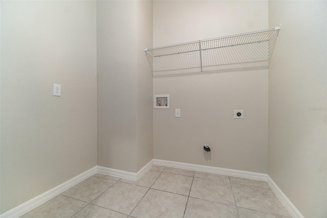 laundry room featuring washer hookup, electric dryer hookup, and light tile patterned flooring