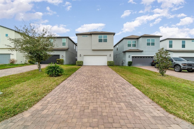 view of property with a garage and a front lawn