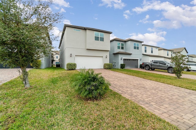 view of front of home with a front yard and a garage