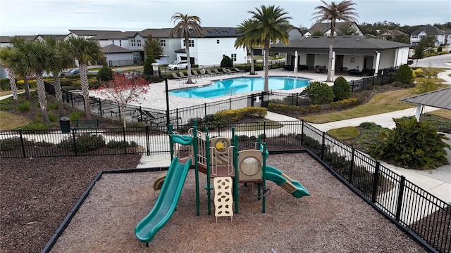 view of pool featuring a patio area and a playground