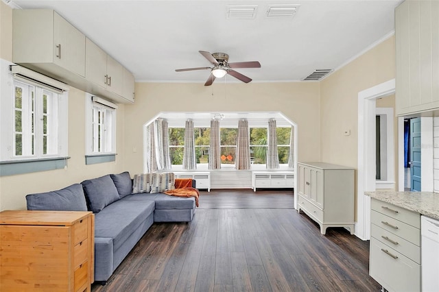 living room with a healthy amount of sunlight, ceiling fan, ornamental molding, and dark hardwood / wood-style flooring