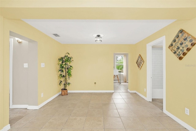 unfurnished room with light tile patterned floors