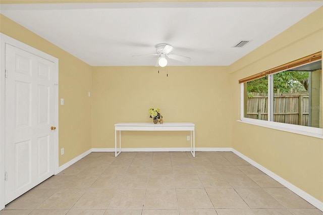 spare room with light tile patterned flooring and ceiling fan