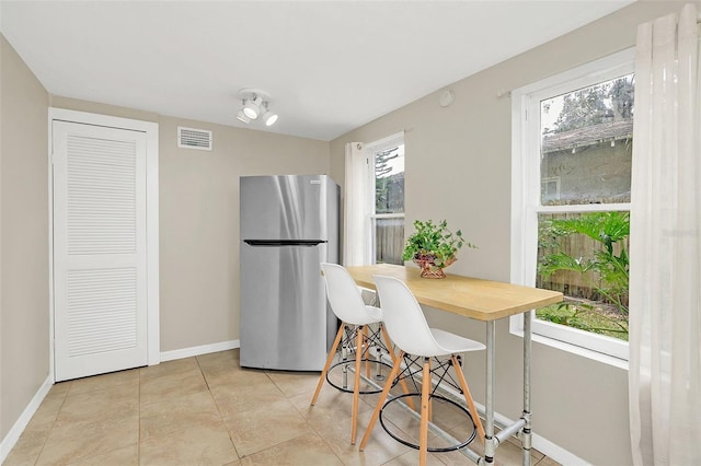 dining space with light tile patterned floors