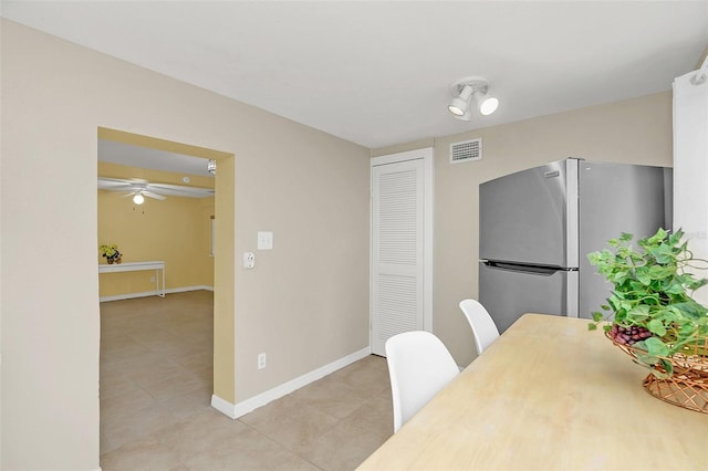 tiled dining area with ceiling fan