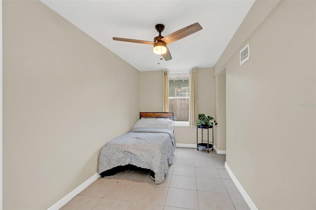 tiled bedroom with ceiling fan