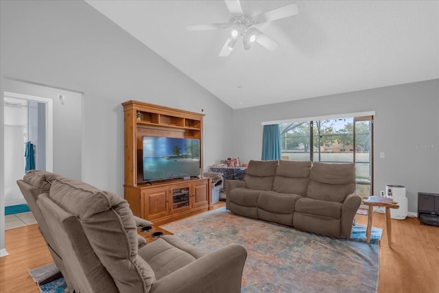 living room with ceiling fan, high vaulted ceiling, and light hardwood / wood-style floors